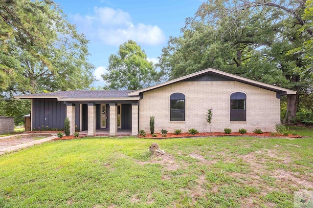 single story home with covered porch and a front lawn