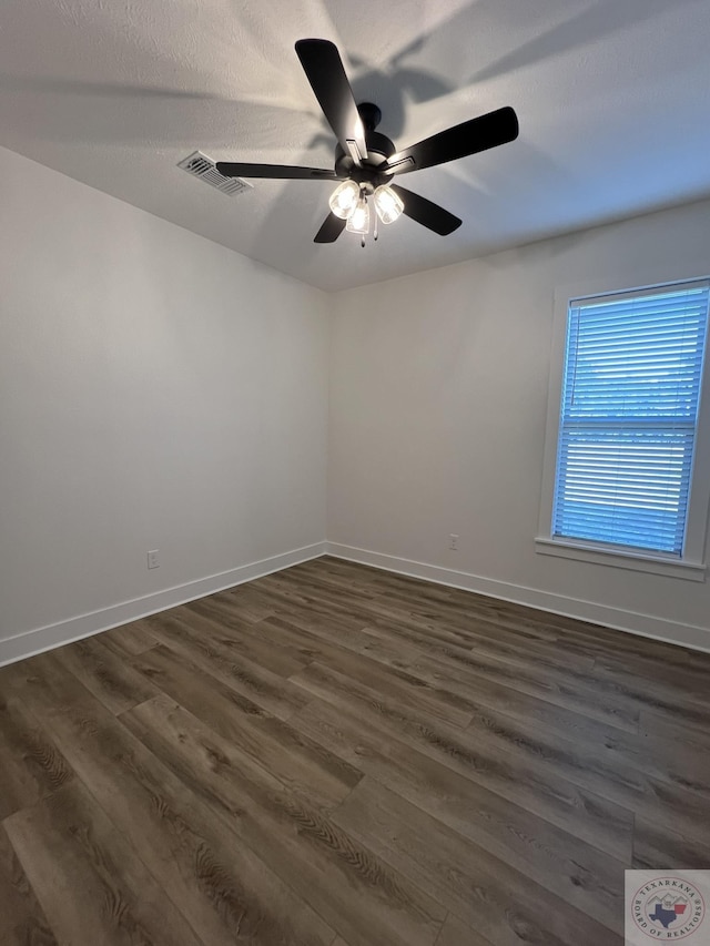 unfurnished room featuring ceiling fan and dark hardwood / wood-style floors