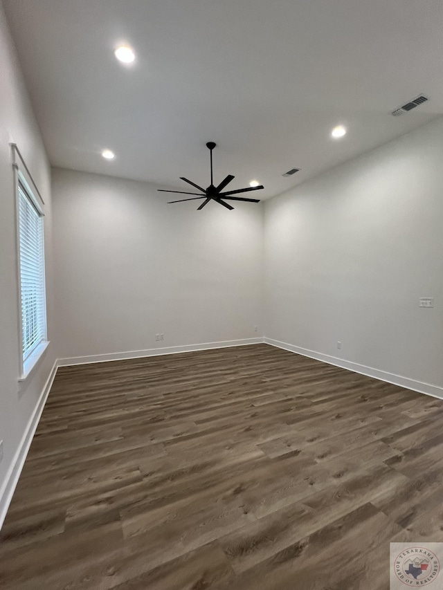 unfurnished room featuring ceiling fan and dark wood-type flooring