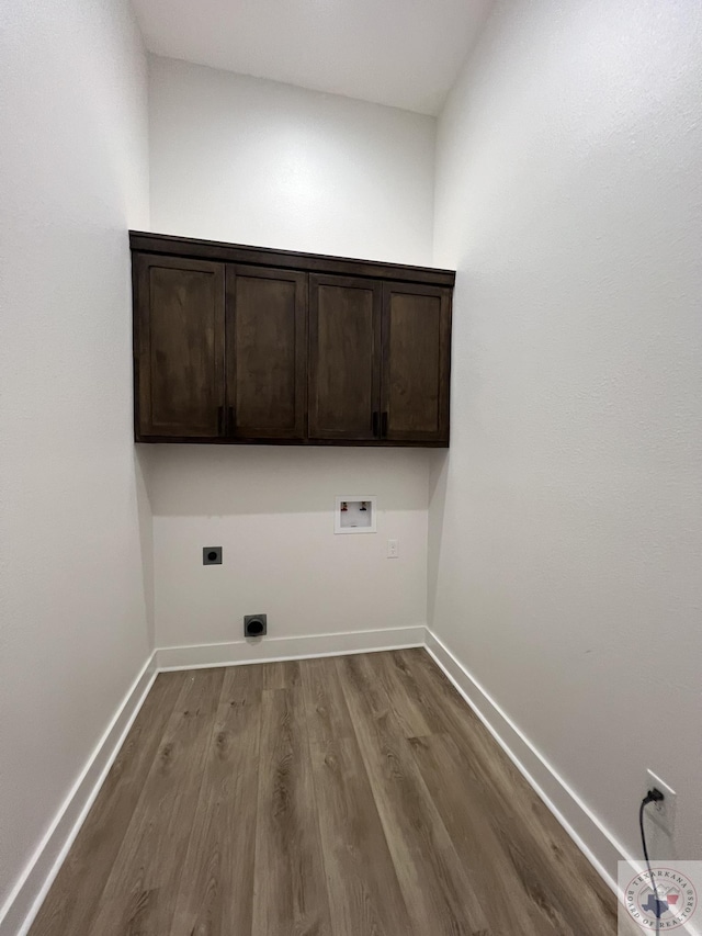 washroom featuring hookup for an electric dryer, cabinets, hookup for a washing machine, and hardwood / wood-style floors