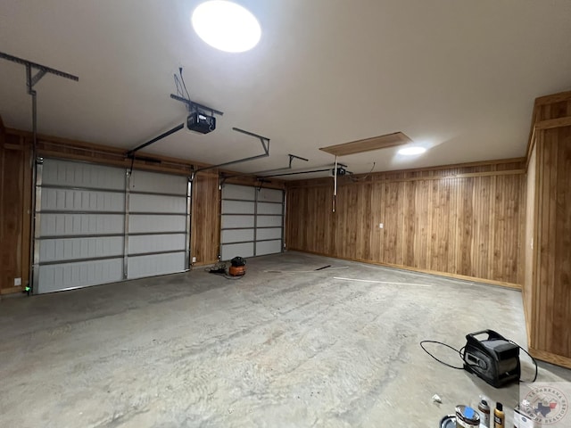 garage featuring wooden walls and a garage door opener