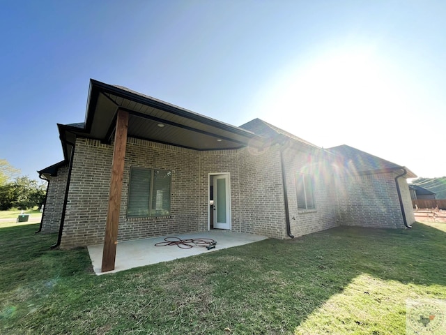 rear view of property with a patio area and a lawn