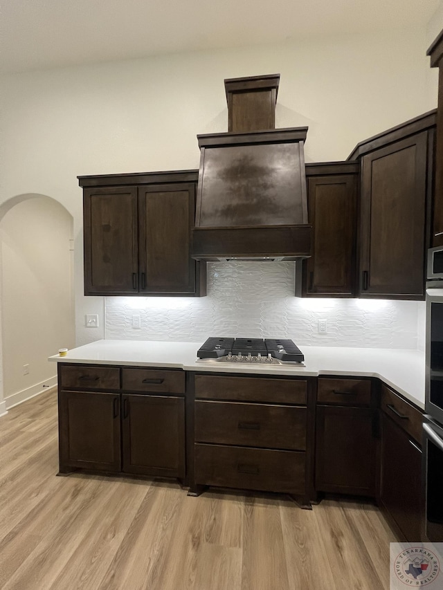 kitchen featuring light hardwood / wood-style floors, dark brown cabinetry, and stainless steel gas cooktop