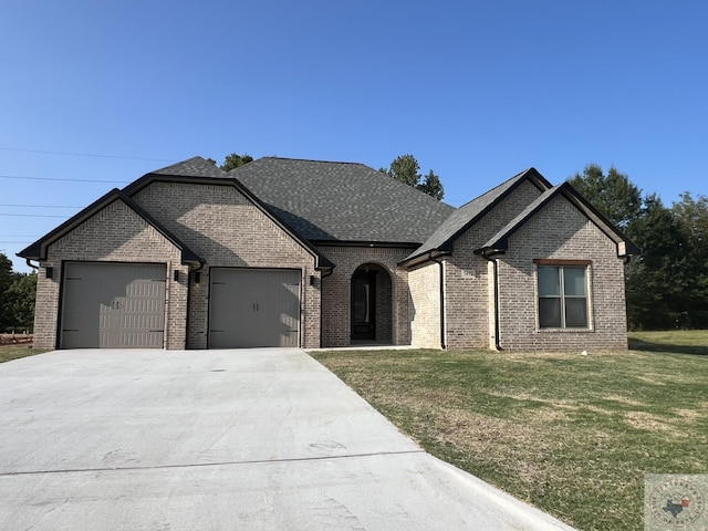 view of front of home featuring a garage and a front lawn