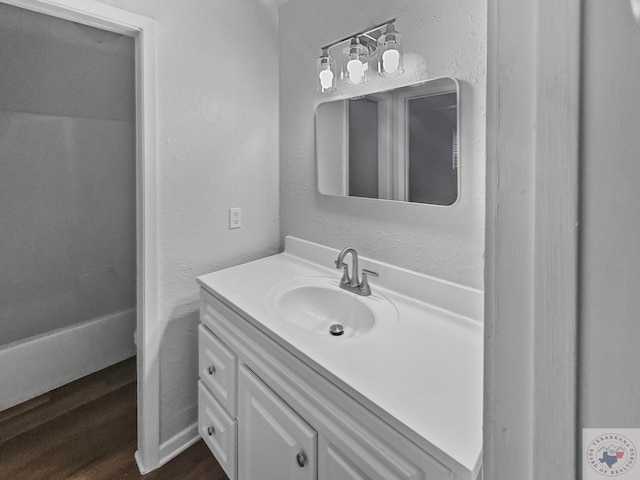 bathroom with hardwood / wood-style flooring and vanity