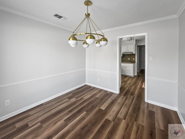 unfurnished dining area with ornamental molding, dark wood-type flooring, and an inviting chandelier