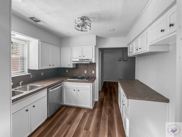 kitchen featuring tasteful backsplash, white cabinetry, stainless steel dishwasher, gas cooktop, and tile countertops