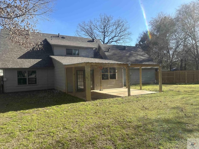 back of property with a lawn and a patio