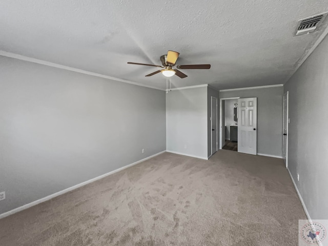 carpeted empty room featuring ceiling fan, crown molding, and a textured ceiling