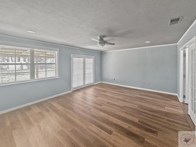 unfurnished bedroom with ceiling fan, wood-type flooring, crown molding, and a textured ceiling