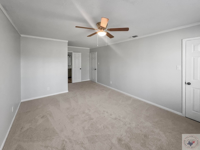 interior space with a textured ceiling, light carpet, and ornamental molding