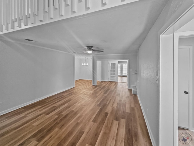 unfurnished living room with hardwood / wood-style flooring and ceiling fan