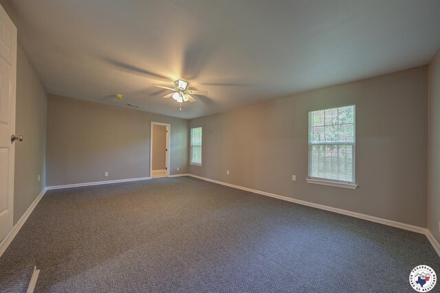 1107 Wheeler St, Texarkana, TX 75501 - empty room featuring a ceiling fan, baseboards, and dark carpet