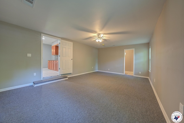 1107 Wheeler St, Texarkana, TX 75501 - unfurnished room with ceiling fan, baseboards, and dark colored carpet