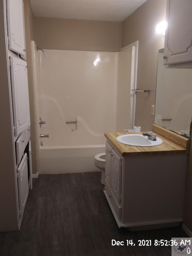 full bathroom featuring vanity, toilet, shower / washtub combination, and wood-type flooring