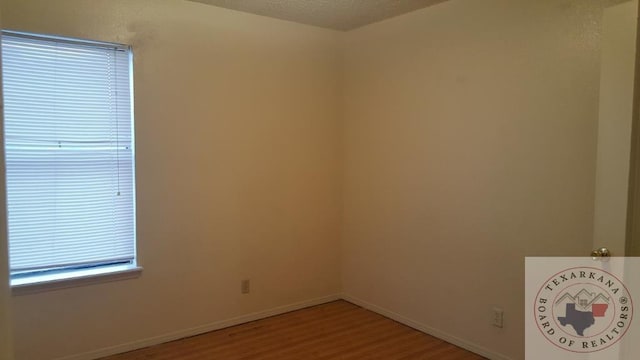 unfurnished room with hardwood / wood-style flooring