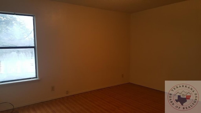 empty room with wood-type flooring