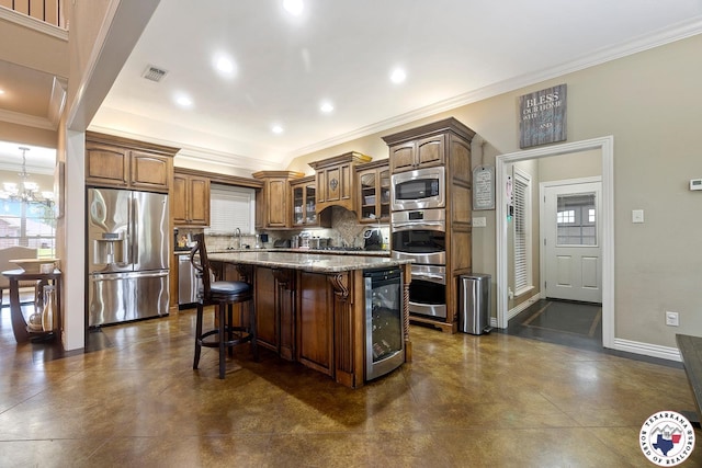 5710 Clearwood Trl, Texarkana, AR 71854 - kitchen with stainless steel appliances, beverage cooler, crown molding, a kitchen island, and a breakfast bar area