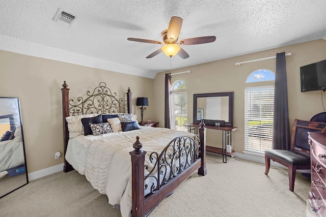 bedroom with ceiling fan, a textured ceiling, carpet floors, and lofted ceiling