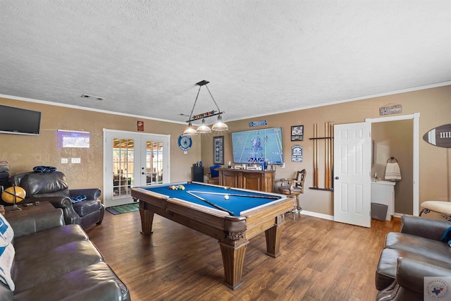 game room featuring crown molding, hardwood / wood-style floors, a textured ceiling, and french doors