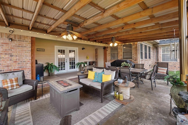 view of patio with an outdoor living space with a fire pit, ceiling fan, and french doors