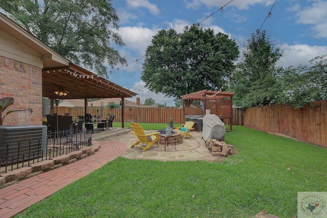 view of yard with a patio, central AC unit, and a fire pit