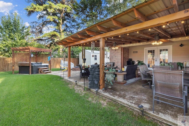 view of yard with a patio area, a hot tub, a storage shed, and french doors