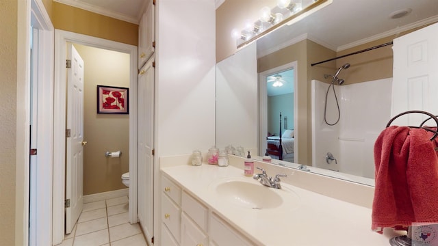 bathroom with tile patterned floors, vanity, crown molding, and toilet