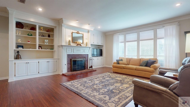 living room with a fireplace, dark wood-type flooring, and crown molding