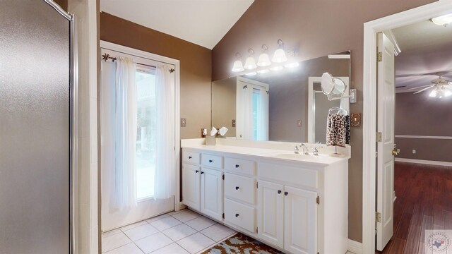 bathroom with a shower with door, tile patterned floors, lofted ceiling, and a wealth of natural light