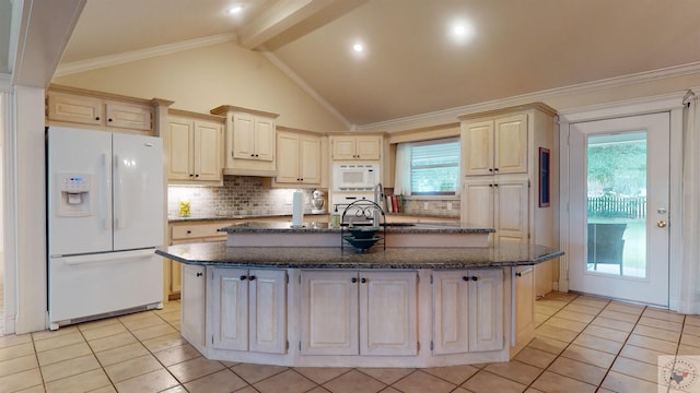 kitchen featuring white appliances, a kitchen island with sink, beamed ceiling, and tasteful backsplash