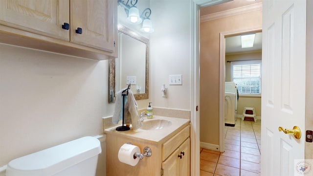 bathroom featuring tile patterned floors, toilet, crown molding, and vanity