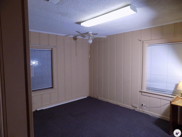 4024 Main St, Texarkana, TX 75503 - unfurnished room with a decorative wall, a textured ceiling, and dark colored carpet