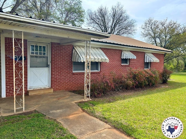 120 N St, Douglassville, TX 75560 - exterior space with a lawn, metal roof, and brick siding