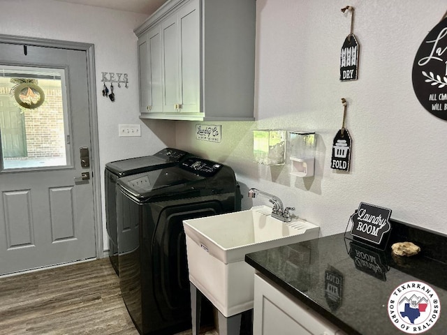 19913 Fm 125, Bivins, TX 75555 - washroom featuring cabinet space, washing machine and dryer, a sink, and dark wood-type flooring