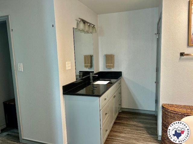 19913 Fm 125, Bivins, TX 75555 - bathroom with wood finished floors, vanity, and baseboards