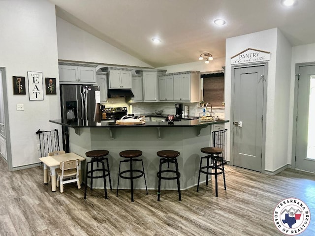 19913 Fm 125, Bivins, TX 75555 - kitchen featuring stainless steel fridge with ice dispenser, light wood-type flooring, a breakfast bar, electric stove, and gray cabinetry