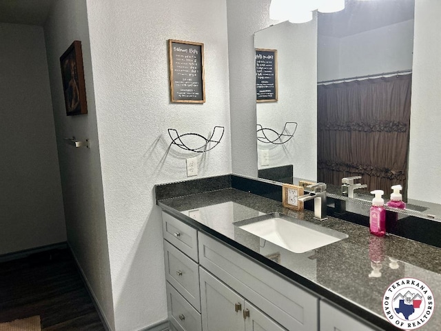 19913 Fm 125, Bivins, TX 75555 - full bathroom featuring wood finished floors, a textured wall, and vanity