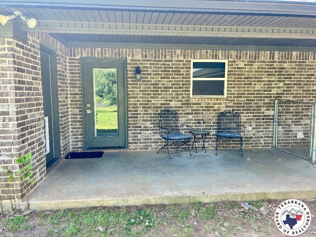 19913 Fm 125, Bivins, TX 75555 - view of exterior entry featuring brick siding and a patio area