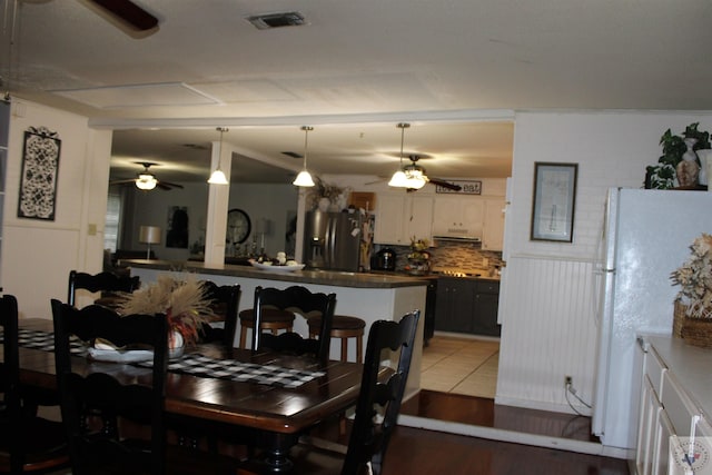 dining area with hardwood / wood-style flooring and ceiling fan