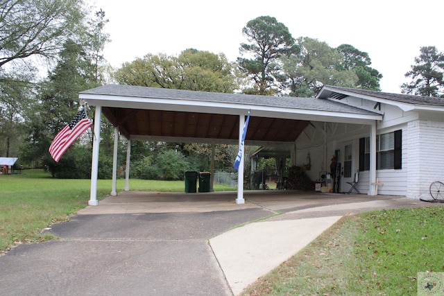 view of parking with a yard and a carport