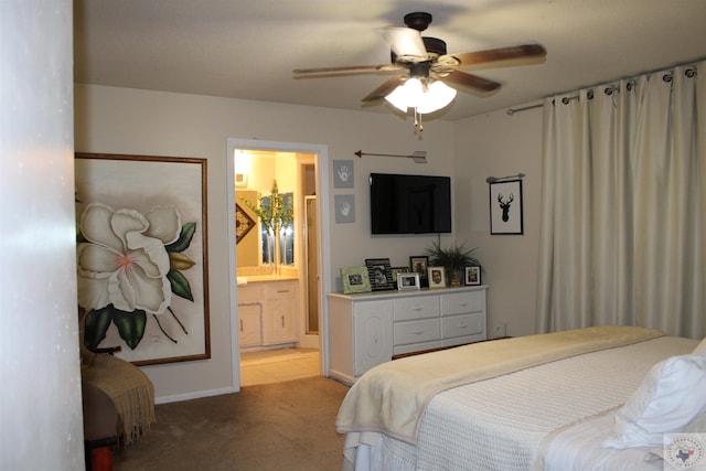 bedroom with ceiling fan, ensuite bathroom, and light carpet