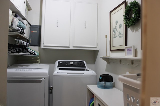 laundry area with washing machine and dryer, electric panel, and cabinets