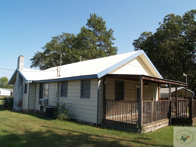 view of property exterior featuring central air condition unit, a lawn, and cooling unit