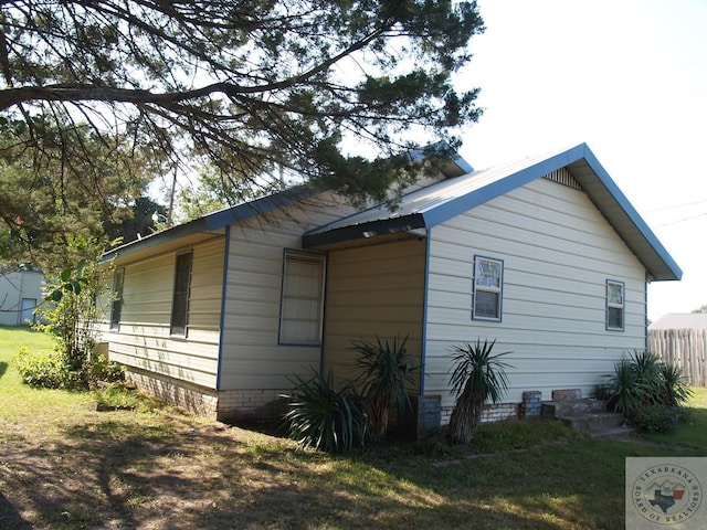 view of side of property with a lawn