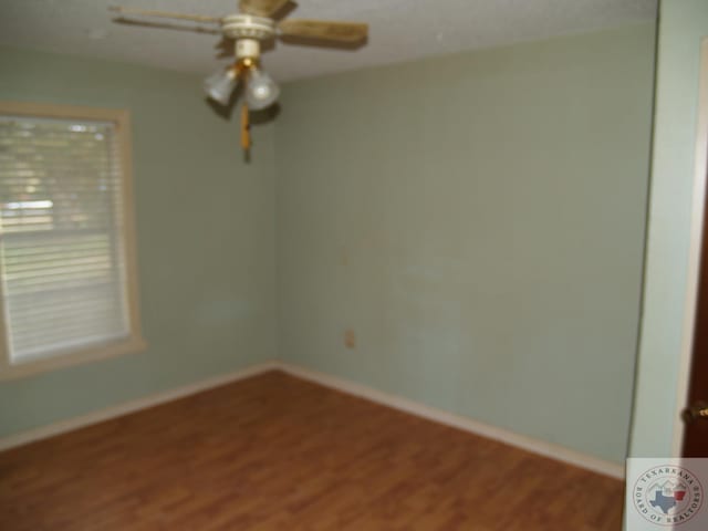 unfurnished room with hardwood / wood-style floors and ceiling fan