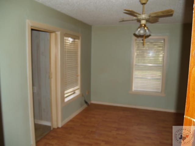 spare room with wood-type flooring and a textured ceiling