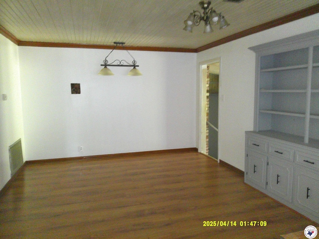 unfurnished dining area with light wood-type flooring, baseboards, visible vents, a notable chandelier, and crown molding