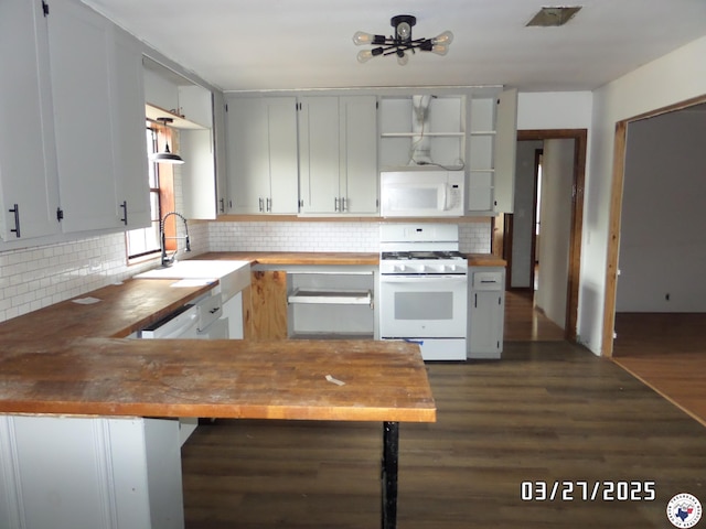 kitchen with tasteful backsplash, open shelves, a sink, wood counters, and white appliances