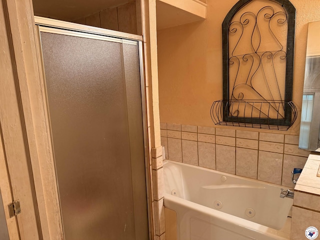 bathroom featuring a shower stall and a whirlpool tub